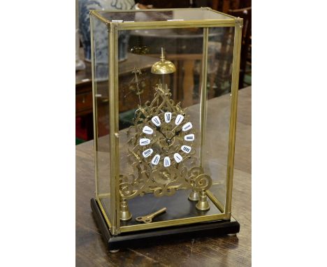 A contemporary cased bell top skeleton clock