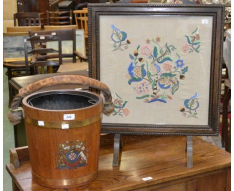 A brass coopered log bucket with coat of arms and rope handle; an oak fire screen with tapestry panel (2)