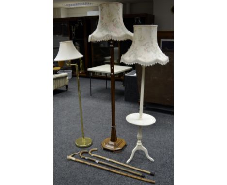 A 1930/40's oak standard lamp; another, painted; a gilt metal standard lamp; a horn handles walking stick; two bentwood walki