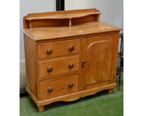 A Victorian stripped pine kitchen sideboard, shaped shelf and turned columns to galleried superstructure, moulded top, three 