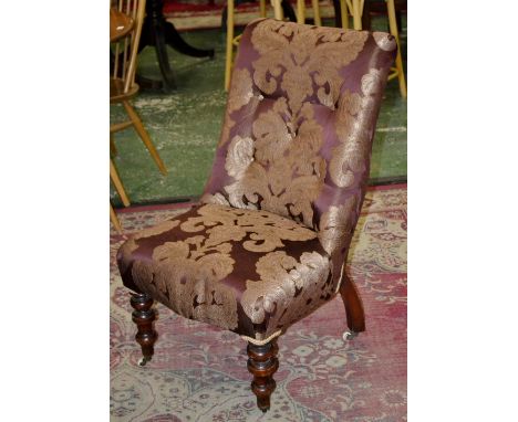 A Victorian mahogany nursing chair, button back, serpentine stuffed over seat, turned forelegs, ceramic casters, circa 1880.