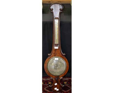 A mid-19th century mahogany wheel barometer onion top, silvered dial and thermometer.