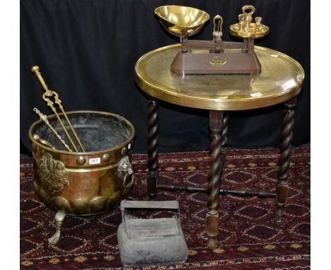Metalware - a large brass coal/log basket, embossed with lion rampant, shield and sabre, tripod pad feet; a pair of fire tong