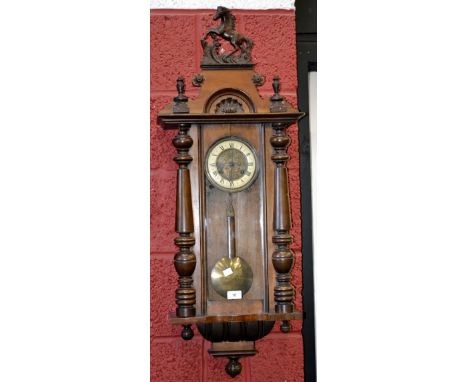 A Victorian mahogany Vienna wall clock, horse rampant to pediment, enamelled chapter ring, Roman numerals flanked by turned p