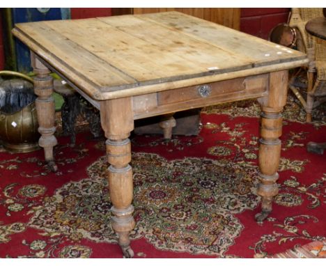 A Victorian pine country kitchen table, plank top, single drawer to frieze, turned supports, ceramic casters. 75cm high x 118
