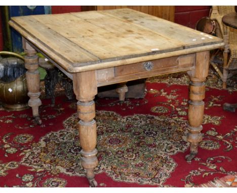 A Victorian pine country kitchen table, plank top, single drawer to frieze, turned supports, ceramic casters. 75cm high x 118