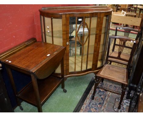 An 1940's oak dropleaf tea trolley; a 1940's walnut veneered display cabinet, serpentine front, cabriole legs; a pair of Edwa