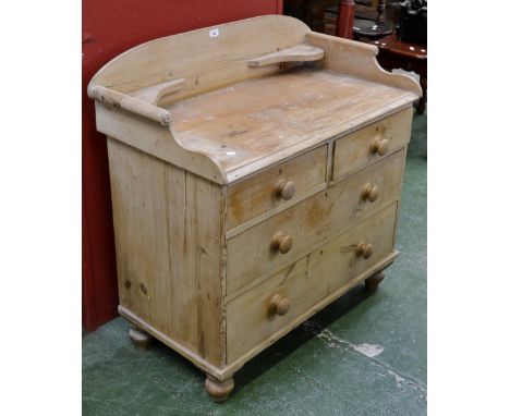 A stripped pine Victorian wash stand, three quarter shelved gallery, two short drawers over two graduated long, button handle