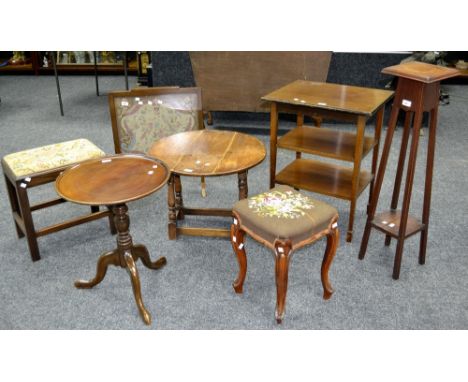 An oak dropleaf occasional table; a  late Victorian tripod table; a mahogany stool; an oak jardiniere stand; an oak framed wo