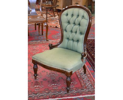 A Victorian style button upholstered spoonback nursing chair. serpentine fronted seat, lobed inverted baluster forelegs.