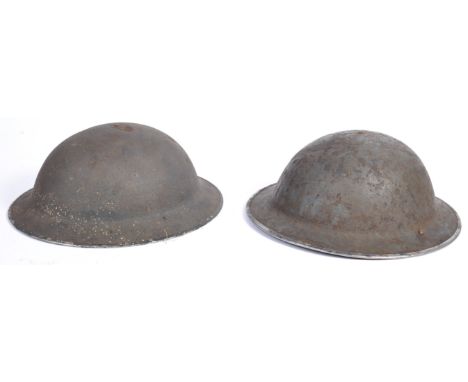 Two original WWII Second World War British Army steel brodie combat helmets. Both complete examples with liners and chin stra