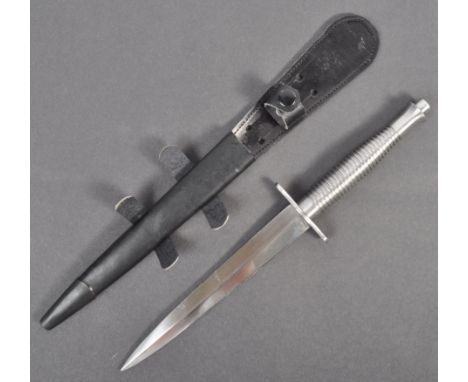 A 20th century FS ' Fairbairn Sykes ' commando fighting knife / dagger. Having a steel ribbed handle, unadorned cross guard a