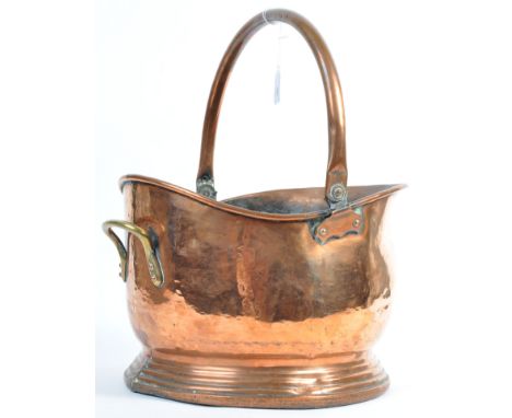 A large 19th Century Victorian coal fire copper scuttle bucket likely used in an officers mess or similar. Helmet shaped buck