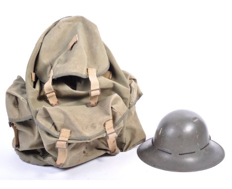 An original WWII Second World War British Army backpack and Zuckerman civil defence helmet. The military issue canvas backpac