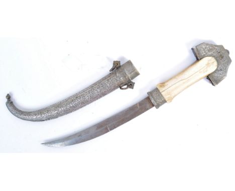 An antique 19th century Middle Eastern Jambiya dagger. The dagger with a large carved bone handle, mounted with a silver whit