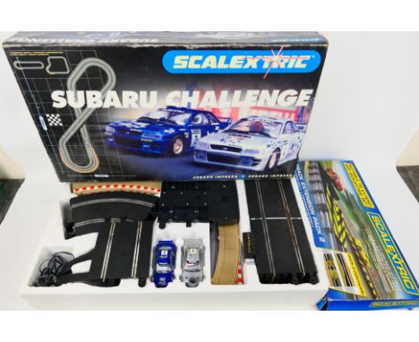 Scalextric - A boxed Scalextric Subaru Challenge' set and a Scalextric Track Extension Pack 2. Set includes a quantity of tra