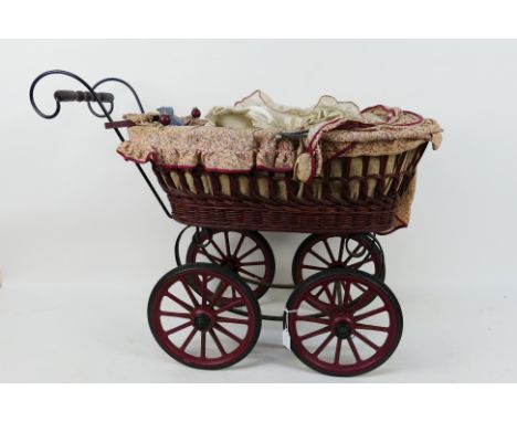 Unbranded - A vintage style dolls pram with a wicker body and metal frame measuring 70 cm including handle by 52 x 33. It app