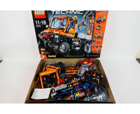 Lego - Technic. A boxed Lego Technic motorized Mercedes Benz Unimog # 8110. The box has been opened, partially assembled and 