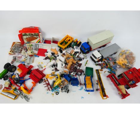 Britains - A collection of unboxed vehicles and farm accessories including 2 x trucks, a Deutz tractor, Massey Ferguson seed 