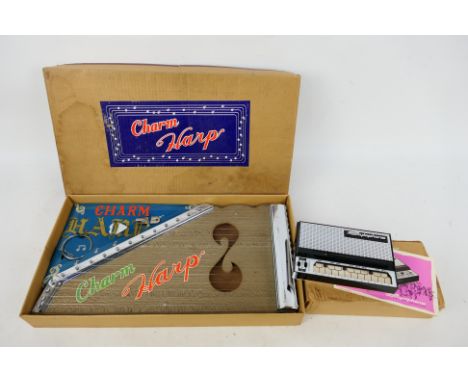 Dubreq - FMT - A boxed Stylophone and a boxed Charm Harp. The items both appear Near Mint with only very light signs of age i