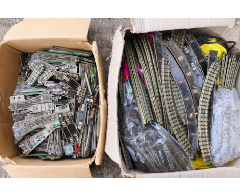 Hornby Dublo - Two cardboard boxes containing a large quantity of Hornby Dublo 3-rail track. Lot contains straights and curve