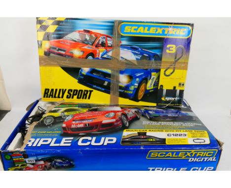 Scalextric - Two boxed Scalextric sets. Lot consists of a 'Triple Cup' set - with one one Porsche car; plus a 'Rally Sport' s