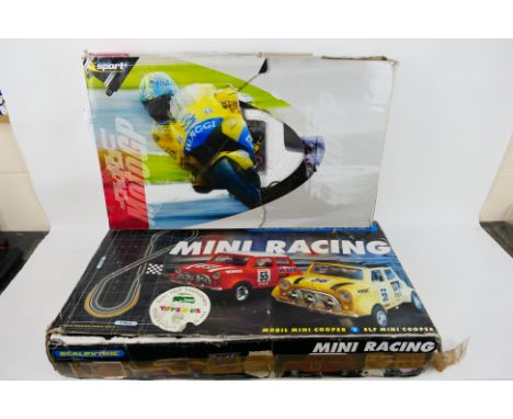 Scalextric - Two boxed Scalextric sets. Lot consists of a 'Mini Racing' set with three mini cars; plus a 'Moto GP World Champ