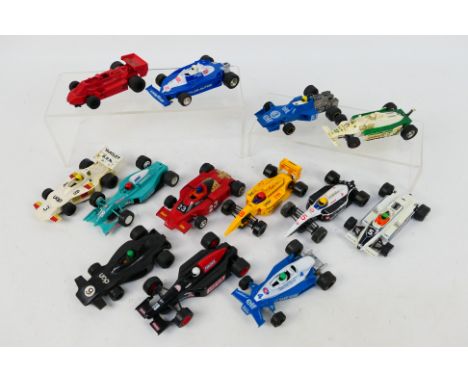 Scalextric - A grid of 13 unboxed playworn Scalextric Formula 1 / Formula 2 slot cars. Lot includes C012 Shadow; Formula 2 Ty