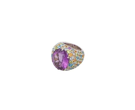 An amethyst and multi gem set bombe dress ring The large central oval shaped mixed-cut amethyst within a pavÃ©-set multi gem 