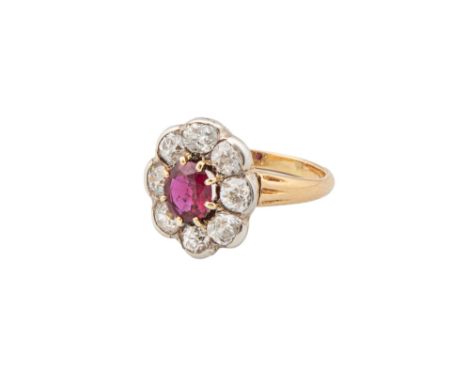 A ruby and diamond cluster ring Within a surround of eight old brilliant cut diamonds in rub over setting  Weight: (Ruby) App