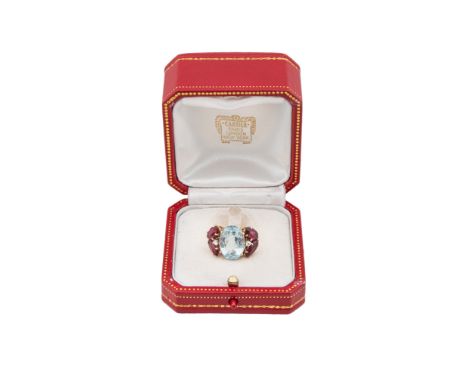 Property of a Noblewoman  An aquamarine and red tourmaline dress ring In a red leather and gilt embossed Cartier presentation