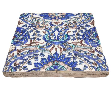 Persian, Qajar 19th Century A moulded tile with mixed tulips and arches, the background white with foliage