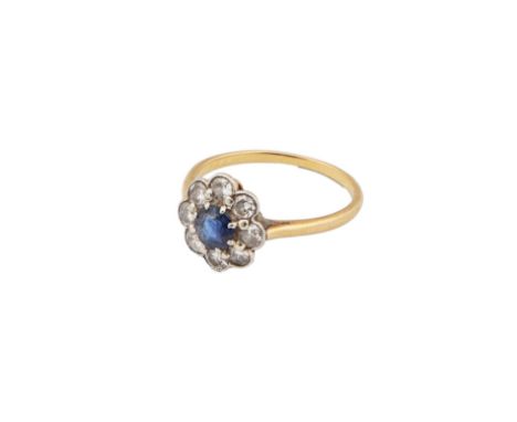 Edwardian  A circular cut sapphire cluster ring Â&nbsp; Within a surround of eight round brilliant cut diamondsÂ&nbsp; Millgr