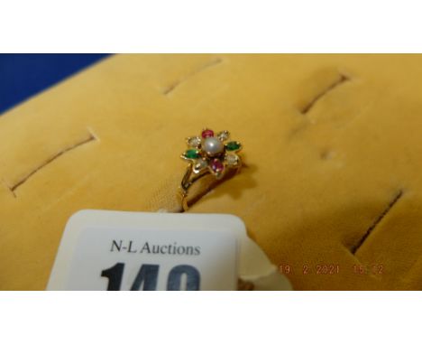 An 18ct gold, Ruby, Emerald, Diamond cluster ring