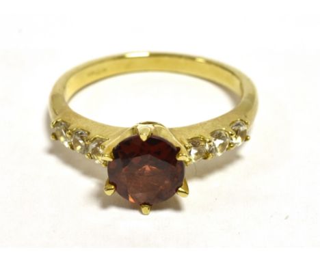 GARNET DRESS RING White quartz set shoulders, yellow metal band, shank marked 9k- small other markings, ring size O, Weight 3