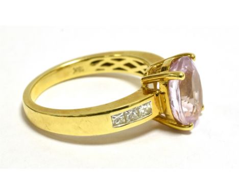 ILIANA 18K MORGANITE AND DIAMOND DRESS RING. The oval faceted Morganite measuring 10mm x8mm,  diamond set shoulders, ring siz