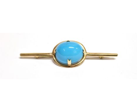 NATURAL TURQUOISE BROOCH An intense sky blue turquoise oval cabochon, approx 19.4 x 16.1mm, in a 9ct gold handmade frame on a
