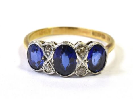 ART DECO 18CT GOLD SAPPHIRE &amp; DIAMOND RING The ring set with three oval faceted sapphires of Royal Blue shades. The centr