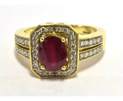 ILIANA 18k RUBY AND DIAMOND COCKTAIL RING Faceted oval ruby measuring 7.5 x 5mm approx set in a diamond accent octagonal plaq