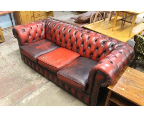 A CHESTERFIELD STYLE THREE SEATER SOFA, IN NEED OF REFURBISHMENT