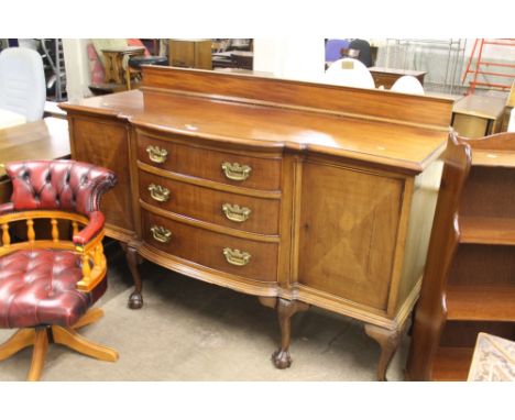 AN EDWARDIAN BOW FRONTED SIDEBOARD WITH CLAW AND BALL FEET AND BRASS HANDLES