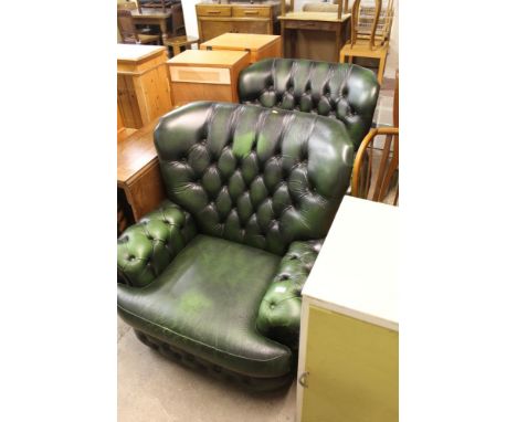 A PAIR OF BUTTON BACKED GREEN LEATHER ARMCHAIRS