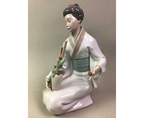 NAO FIGURE OF THE DECORATOR, modelled as a kneeling geisha tending a vase of flowers34cm high