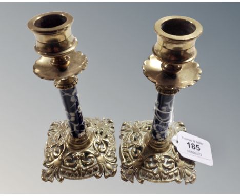 A pair of Victorian brass candlesticks with ceramic stems, height 14.5 cm. (2)