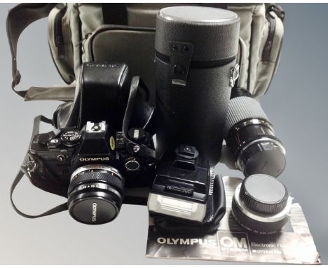 An Olympus OM10 SLR camera with Olympus Zuiko Auto-S 50mm F/1.8 lens and manual, together with additional Ensinor 80-200mm F/