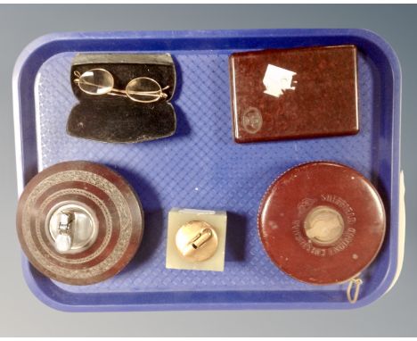 A tray containing vintage Chesterman tape measure, bakelite cigar case, onyx table lighter, further table lighter, a pair of 