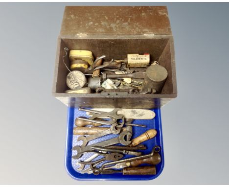 A tray of wooden tool box of assorted hand tools, spanners and pliers, oil can, tins etc 