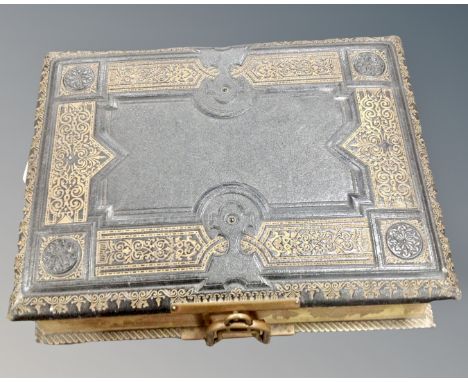 A vintage leather bound musical photograph album containing various portrait photographs, in storage box.