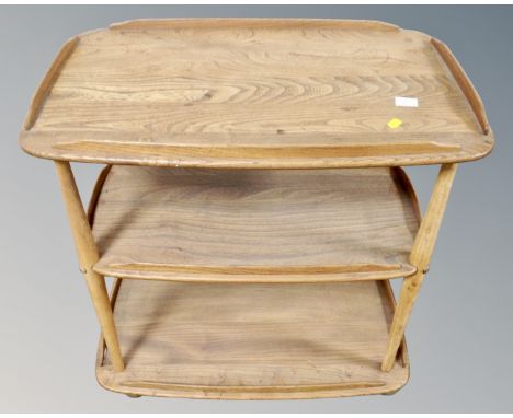 An Ercol elm three tier drinks trolley. (width 71cm)