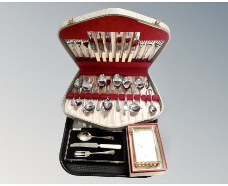 A tray of German mantel clock in box, canteen of stainless steel cutlery, further cased knife fork and spoon set 